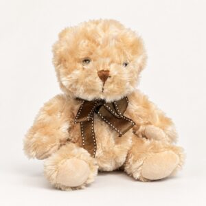 Beige nalle i lockig plysch med brun rosett